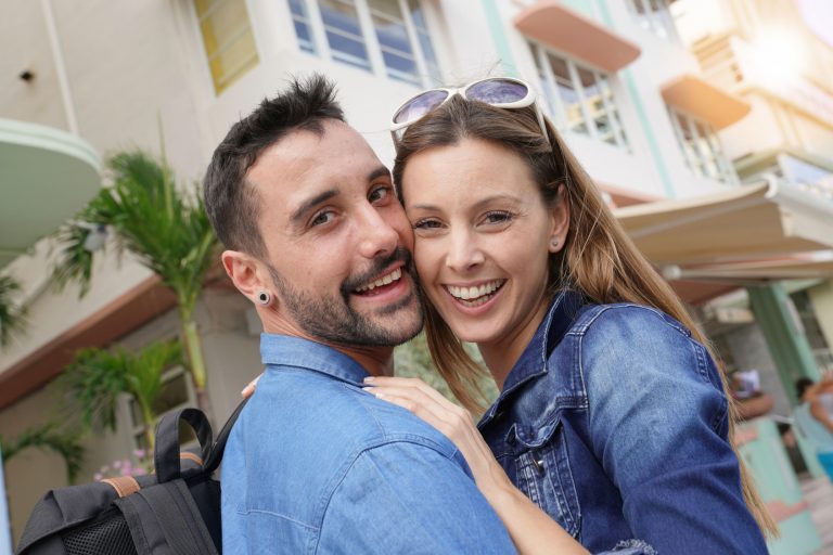 Cheerful young loving couple visiting South beach Miami