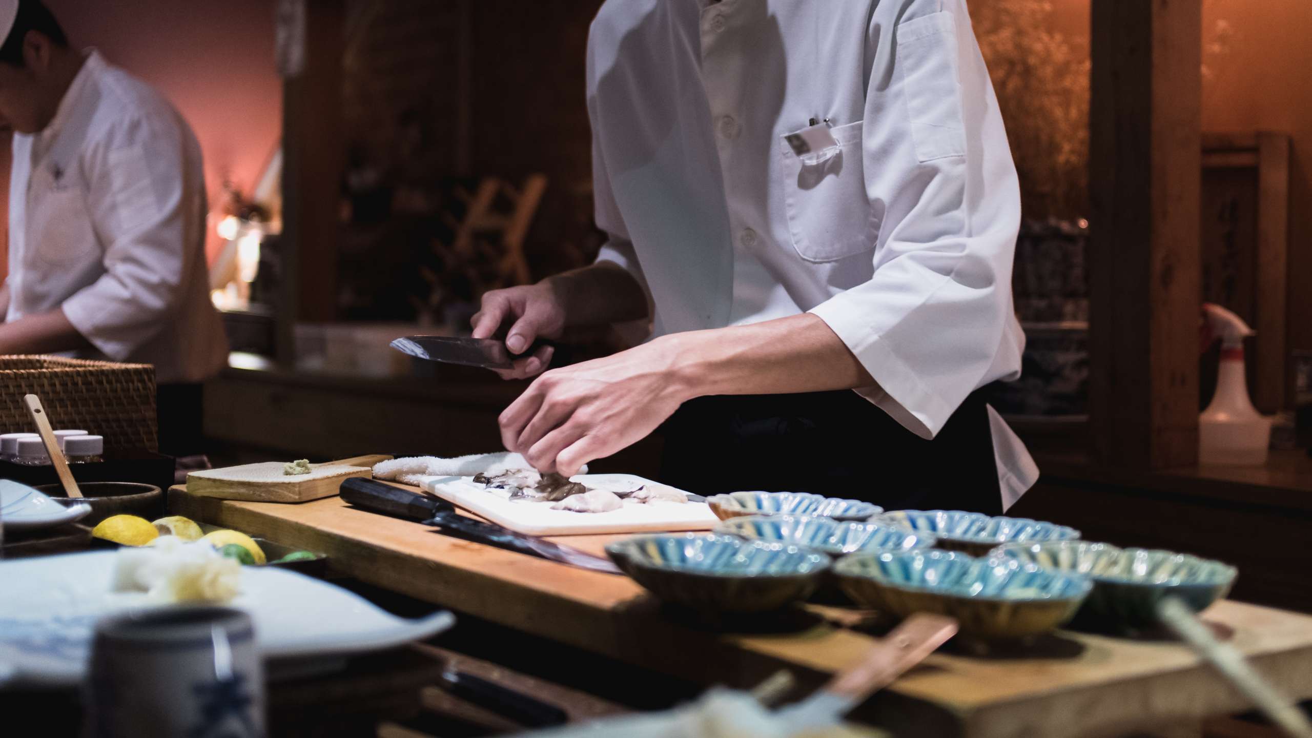 Chef preparing slicing oysters, Omakase style Japanese tradition